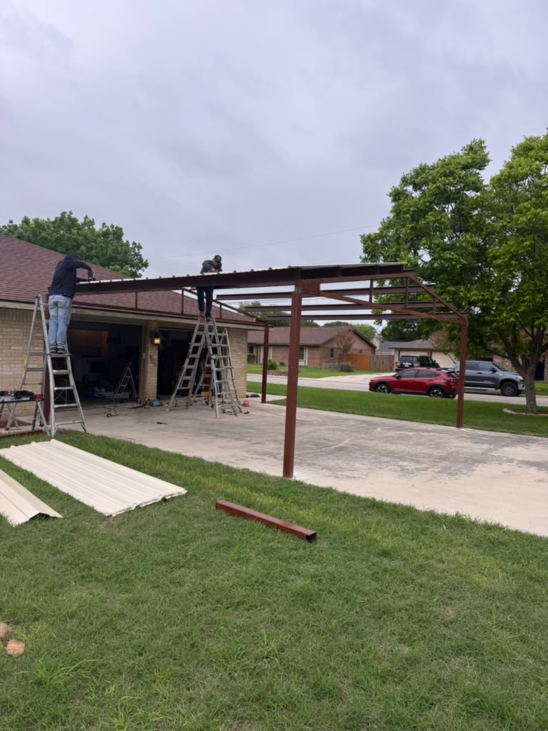 Metal carport installation in progress by Risen Remodeling