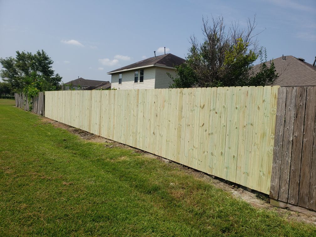 Wood privacy fence installation by Risen Remodeling