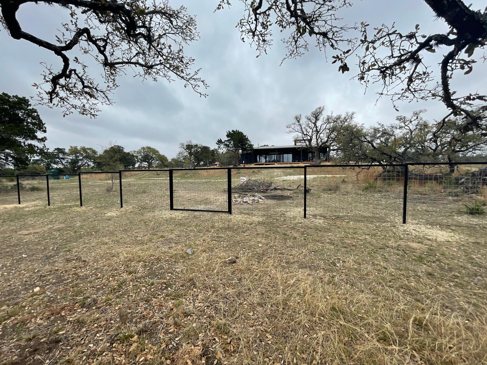 Metal fence with gate installed by Risen Remodeling