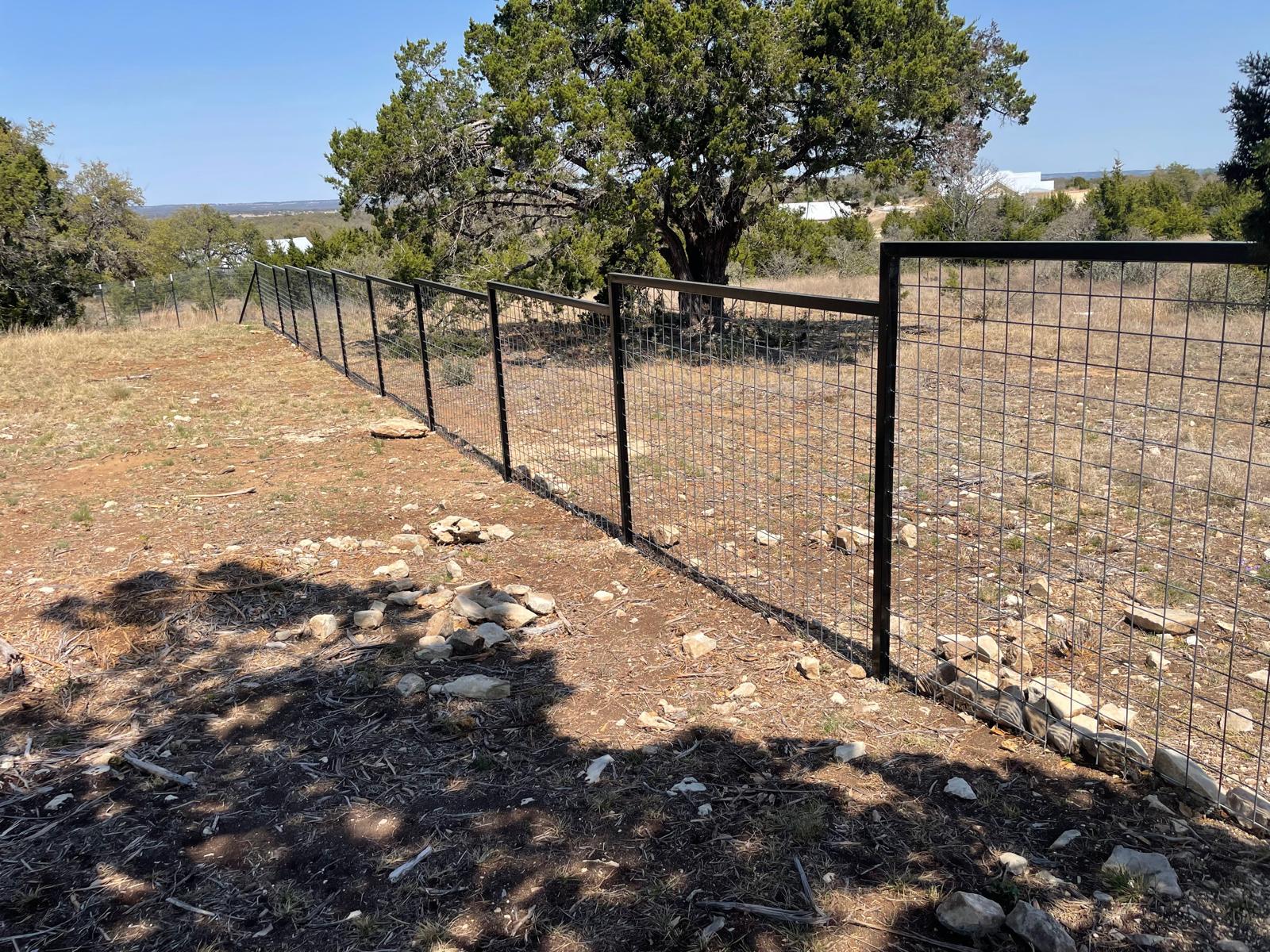 Metal fence with gate installed by Risen Remodeling